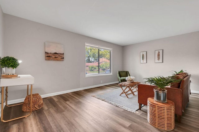 living area with hardwood / wood-style flooring