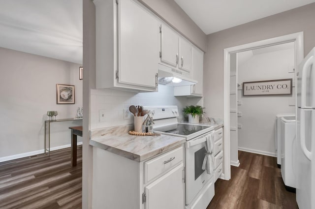 kitchen featuring dark wood-type flooring, washing machine and dryer, backsplash, white appliances, and white cabinets