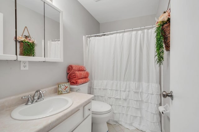 bathroom featuring tile patterned floors, vanity, and toilet