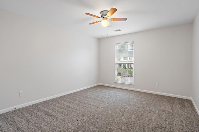 carpeted spare room with ceiling fan