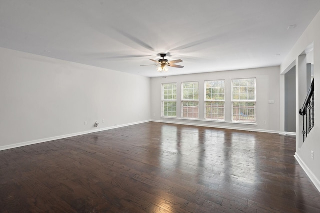 spare room featuring dark hardwood / wood-style flooring and ceiling fan