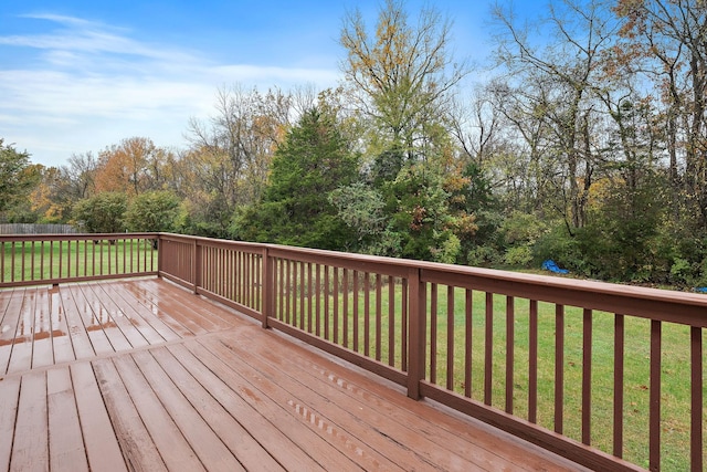 wooden terrace featuring a lawn