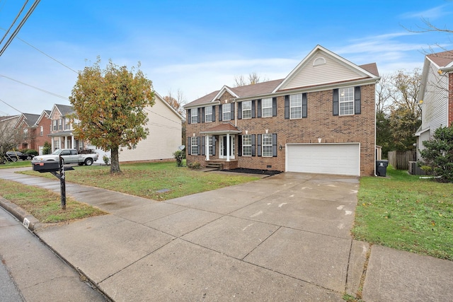 view of front of home with a front yard and a garage