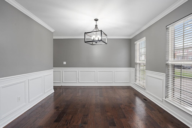 unfurnished dining area featuring plenty of natural light, dark wood-type flooring, and a notable chandelier