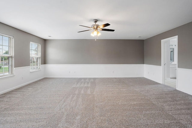 empty room featuring ceiling fan and carpet floors