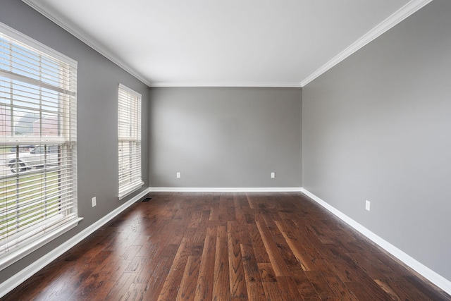 spare room with dark hardwood / wood-style floors and crown molding