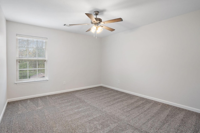 carpeted spare room with ceiling fan