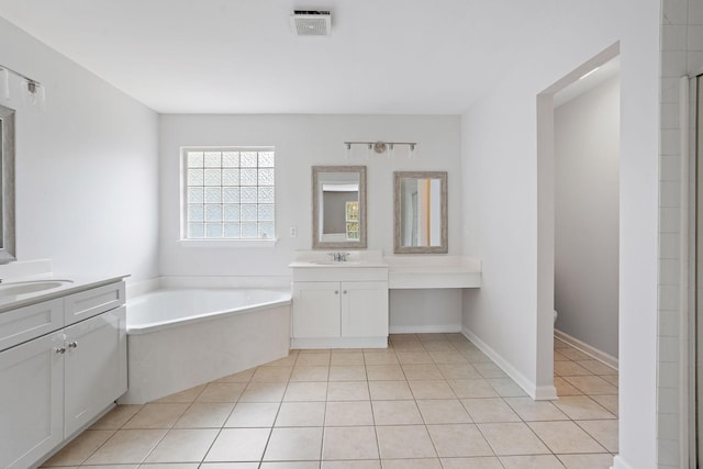 bathroom with tile patterned flooring, vanity, and a washtub