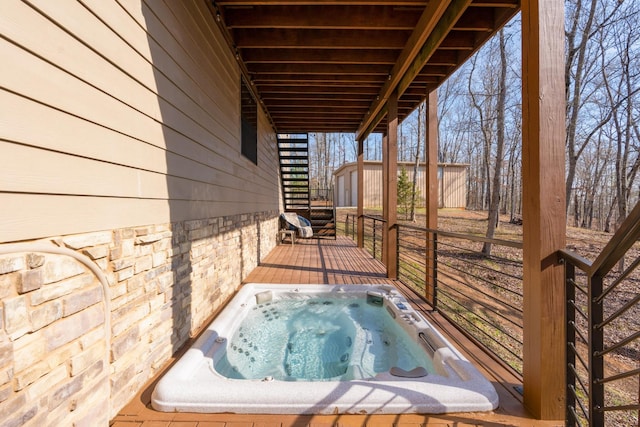 wooden terrace featuring an outdoor hot tub