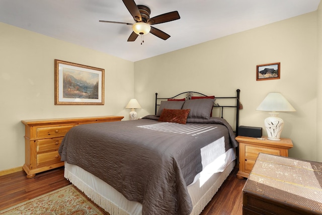 bedroom with ceiling fan and dark wood-type flooring