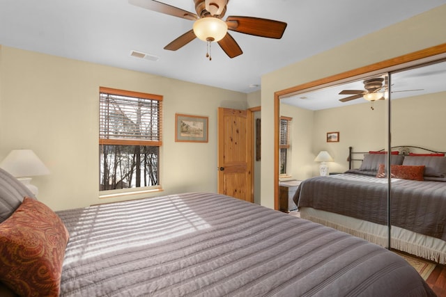 bedroom featuring hardwood / wood-style floors, a closet, and ceiling fan