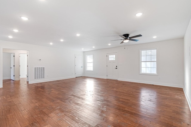 unfurnished living room with ceiling fan and dark hardwood / wood-style flooring