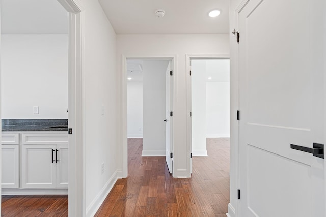 hall with dark hardwood / wood-style flooring