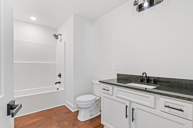 full bathroom featuring hardwood / wood-style floors, vanity, toilet, and shower / bath combination