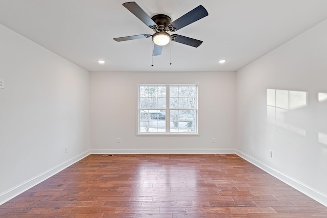 spare room with hardwood / wood-style flooring and ceiling fan