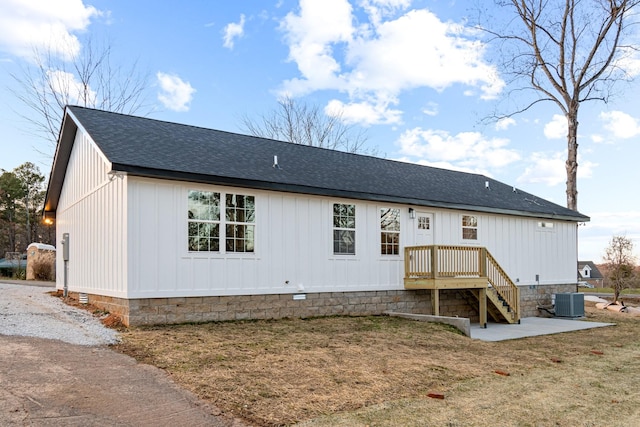 rear view of house featuring a yard, a patio, and central AC unit