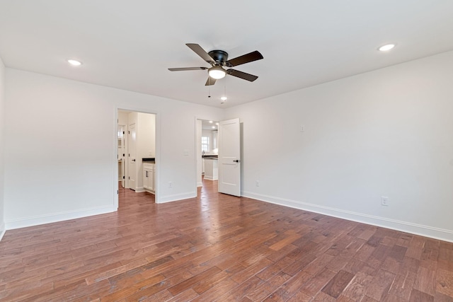 empty room with hardwood / wood-style flooring and ceiling fan