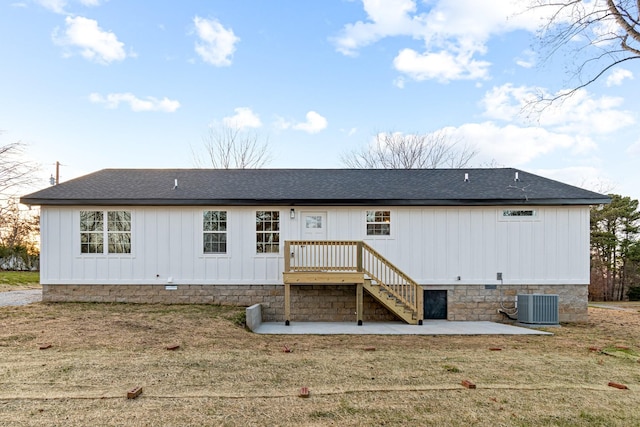 rear view of property featuring a lawn, a patio area, and central AC unit