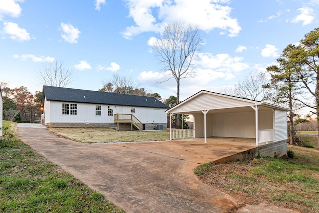 view of front facade with a front lawn and a carport