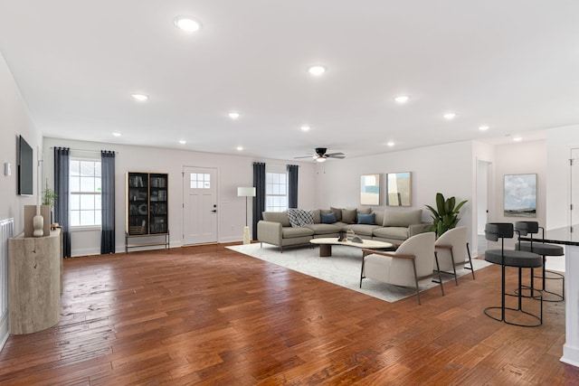 living room featuring hardwood / wood-style flooring and ceiling fan