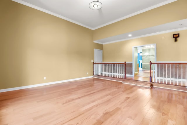 unfurnished room featuring ornamental molding and light wood-type flooring