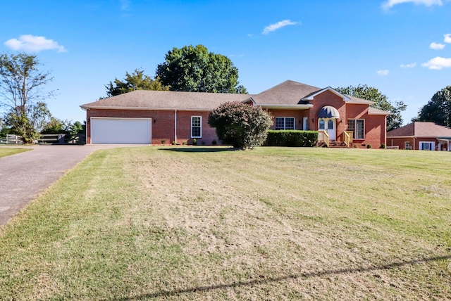 ranch-style home with a garage and a front yard