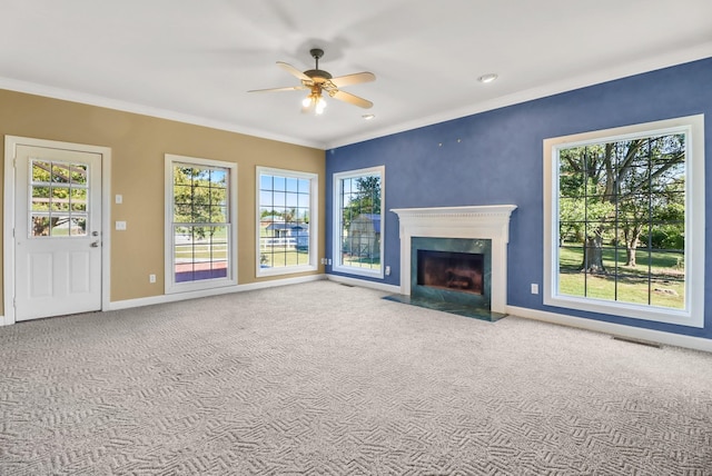 unfurnished living room featuring carpet, ceiling fan, and ornamental molding