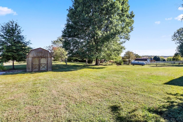 view of yard with a storage unit and a rural view