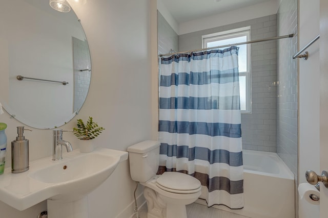 full bathroom featuring toilet, sink, and shower / tub combo