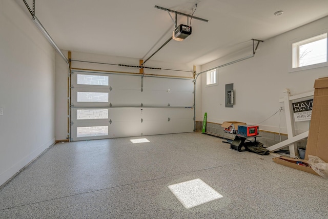 garage with electric panel and a garage door opener