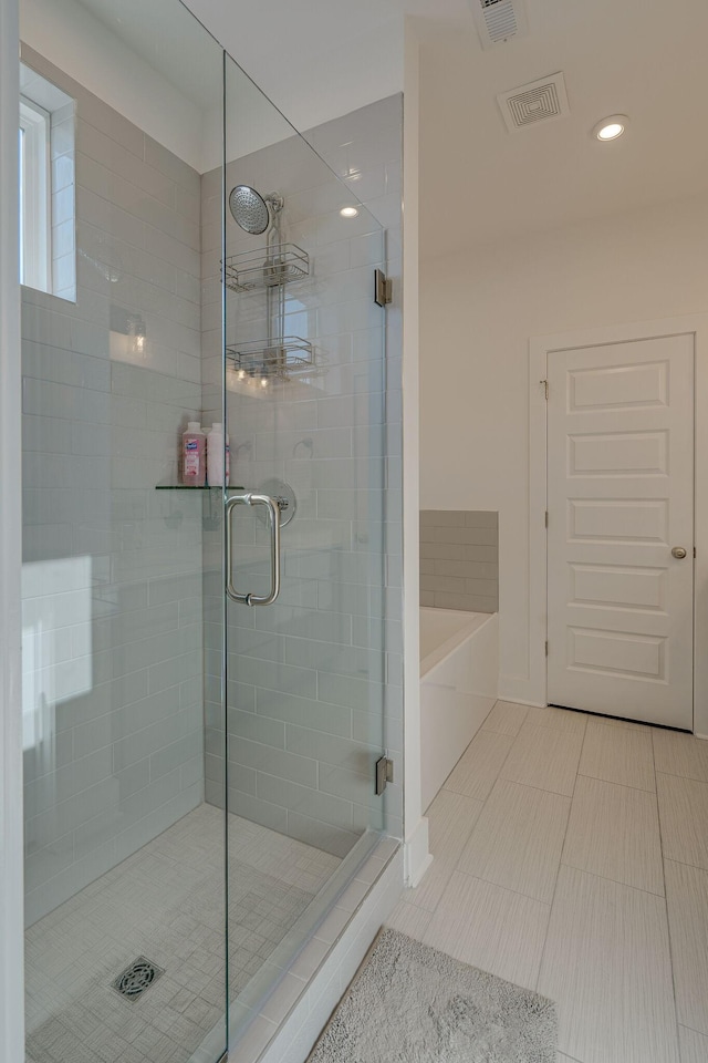 bathroom featuring separate shower and tub and tile patterned flooring