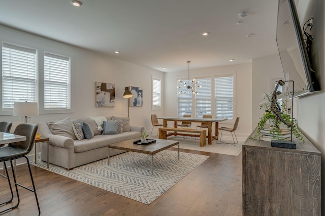 living room featuring hardwood / wood-style floors and an inviting chandelier