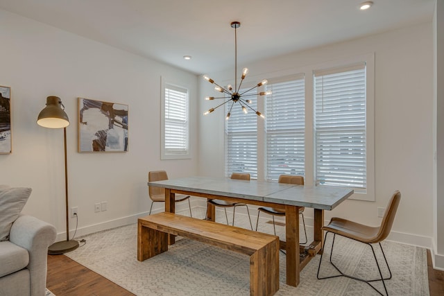 dining area featuring light hardwood / wood-style floors and a notable chandelier