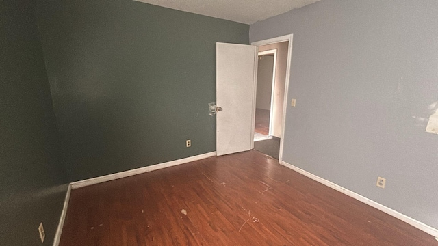 empty room with dark hardwood / wood-style floors