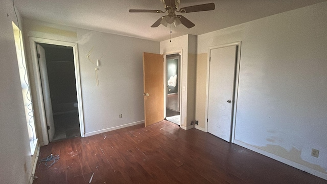 unfurnished bedroom with ceiling fan and dark hardwood / wood-style floors