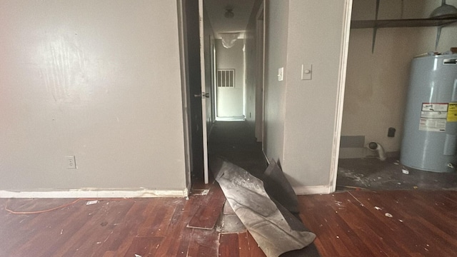 corridor featuring water heater and dark hardwood / wood-style floors