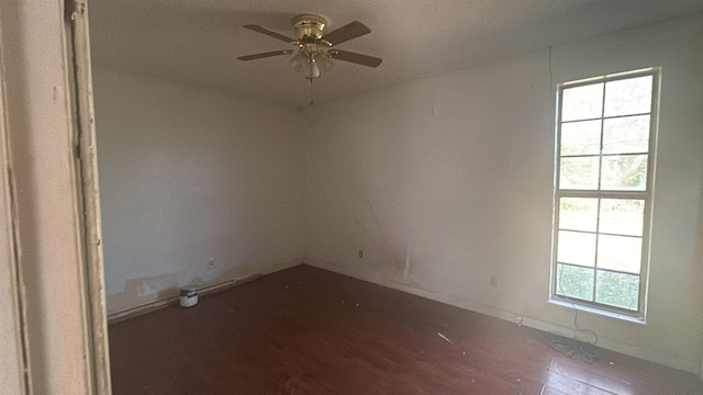 empty room featuring ceiling fan and dark hardwood / wood-style flooring