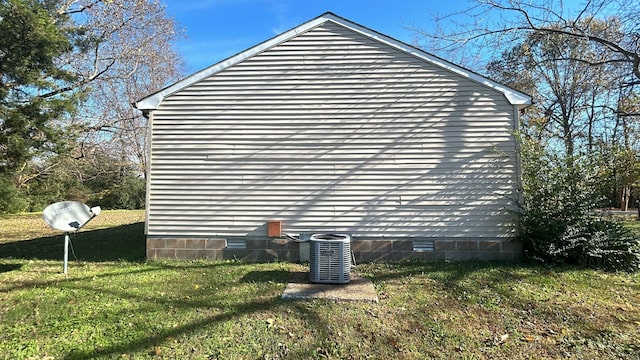 view of home's exterior featuring central AC and a lawn