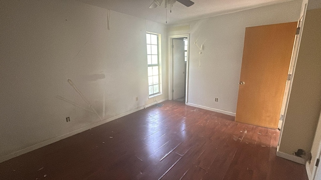 spare room with ceiling fan and dark hardwood / wood-style flooring