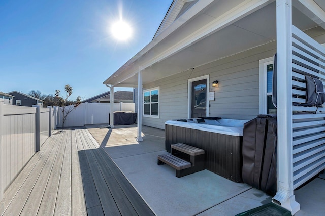 wooden terrace featuring a hot tub