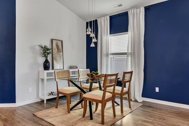 dining area with hardwood / wood-style floors