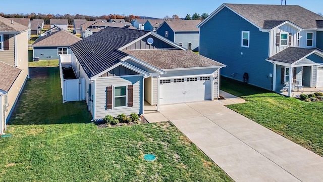 view of front of property featuring a front yard and a garage