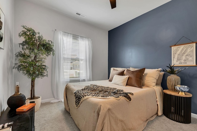 bedroom featuring light carpet and ceiling fan