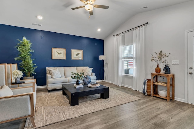 living room featuring hardwood / wood-style floors, vaulted ceiling, and ceiling fan