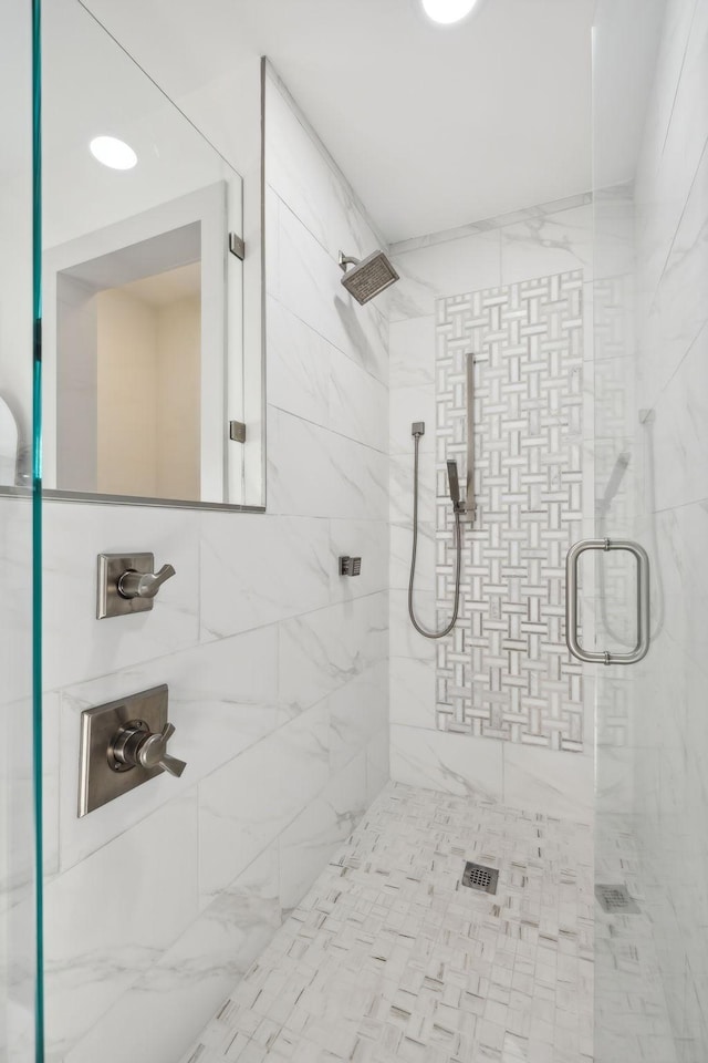 bathroom featuring a shower with shower door