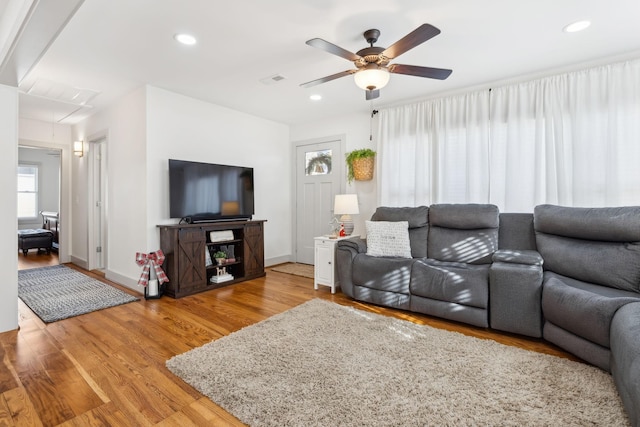 living room featuring ceiling fan and wood-type flooring