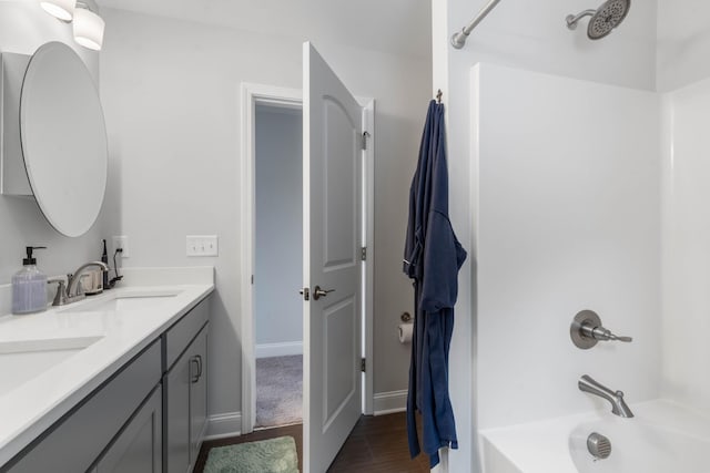 bathroom featuring shower / washtub combination, vanity, and hardwood / wood-style floors