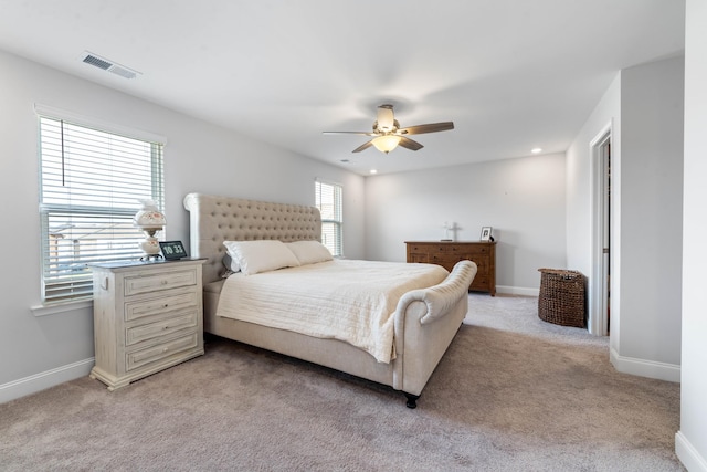 bedroom featuring ceiling fan and light carpet