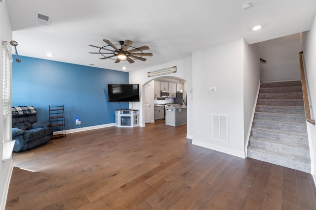 unfurnished living room with ceiling fan and dark hardwood / wood-style floors