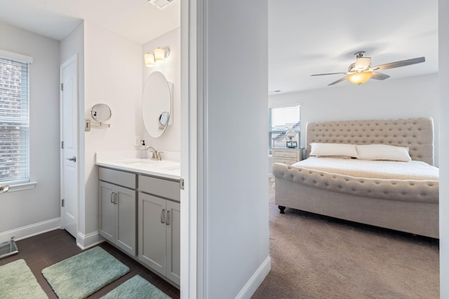 bathroom with hardwood / wood-style floors, vanity, and ceiling fan